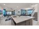 Open-concept kitchen with a large island, stainless steel appliances, and seamless flow into the dining and living areas at 1799 Tropical Palms Cir, Kissimmee, FL 34747