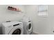 Well-lit laundry room featuring a Whirlpool washer and dryer, plus ample shelving at 1799 Tropical Palms Cir, Kissimmee, FL 34747