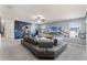 Spacious living room features a large gray sectional sofa, a movie themed wall mural, and large windows at 1799 Tropical Palms Cir, Kissimmee, FL 34747