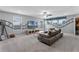 Living room featuring a large gray sectional sofa, movie themed artwork, and a ceiling fan at 1799 Tropical Palms Cir, Kissimmee, FL 34747
