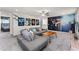Living room featuring a large gray sectional sofa, movie themed artwork, and a ceiling fan at 1799 Tropical Palms Cir, Kissimmee, FL 34747
