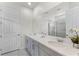 Modern main bathroom with double sinks, a large mirror, white cabinets, and a glass-enclosed shower at 1799 Tropical Palms Cir, Kissimmee, FL 34747