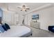Bright main bedroom with a tray ceiling, carpet, a mounted TV, and an ensuite bathroom at 1799 Tropical Palms Cir, Kissimmee, FL 34747