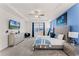 Spacious main bedroom featuring a blue accent wall, tray ceiling, plush carpet, and elegant furnishings at 1799 Tropical Palms Cir, Kissimmee, FL 34747