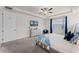 Cozy main bedroom with plush carpet, a tray ceiling, a mounted TV, and ample closet space at 1799 Tropical Palms Cir, Kissimmee, FL 34747