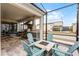 Covered outdoor patio features a built in grill, stainless appliances, and fire pit at 1799 Tropical Palms Cir, Kissimmee, FL 34747