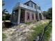 Exterior view of the framing construction, including windows, of a two story house, with mud and grass in the front at 1803 Florinda Dr, Orlando, FL 32804