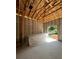 Garage interior, drywall piled up, showing exposed wood framing, concrete block walls, and future door placement at 1803 Florinda Dr, Orlando, FL 32804