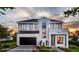 Stunning two-story modern home with a black garage door and manicured lawn at 1803 Florinda Dr, Orlando, FL 32804