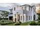 Stunning two-story home boasts modern architecture, a manicured lawn, and elegant black-framed windows at 1803 Florinda Dr, Orlando, FL 32804