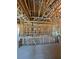 Interior view of the framing construction of a house with exposed beams and utilities at 1803 Florinda Dr, Orlando, FL 32804