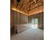 Interior construction view showing an unfinished room with studs, beams, and construction supplies at 1803 Florinda Dr, Orlando, FL 32804