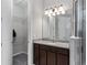 Bathroom featuring a vanity, enclosed shower, and an adjacent walk-in closet at 193 Old Moss Cir, Deland, FL 32724