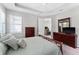 Bedroom with a window, ceiling fan, and a dresser; doorway leads to the living room at 193 Old Moss Cir, Deland, FL 32724