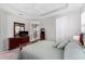 Bright bedroom with a ceiling fan, wood furniture and an attached bathroom with a glass shower at 193 Old Moss Cir, Deland, FL 32724