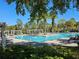 Large community pool with sunbathers on a sunny day at 193 Old Moss Cir, Deland, FL 32724