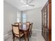 Dining room with a dining table, chairs, china cabinet and windows with plantation shutters at 193 Old Moss Cir, Deland, FL 32724