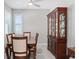 Dining room with a dining table, chairs, china cabinet and windows with plantation shutters at 193 Old Moss Cir, Deland, FL 32724