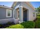 A view of the front door and well maintained landscaping at 193 Old Moss Cir, Deland, FL 32724