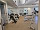 Community gym features dumbbells, weight machines, mirrors, and ceiling fan for a complete fitness experience at 193 Old Moss Cir, Deland, FL 32724