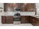 Modern kitchen features stainless steel appliances and backsplash at 193 Old Moss Cir, Deland, FL 32724