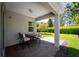 Covered patio with outdoor seating, offering a cozy space for relaxation and enjoying the backyard at 193 Old Moss Cir, Deland, FL 32724
