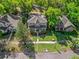 An aerial view of this beautiful home features well manicured lawn and mature shade trees at 208 Hideaway Ct, Minneola, FL 34715