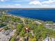 Beautiful lakefront aerial view of the property, showing nearby lake access and local roadways at 208 Hideaway Ct, Minneola, FL 34715