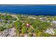 Aerial view shows proximity to lake and surrounding community, nestled within a canopy of trees at 208 Hideaway Ct, Minneola, FL 34715