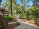 This backyard has a walking path, a seating area, plants, and mulch at 208 Hideaway Ct, Minneola, FL 34715