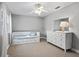 Cozy bedroom with neutral walls, carpet flooring, ceiling fan and a daybed at 208 Hideaway Ct, Minneola, FL 34715