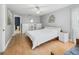 Comfortable bedroom with wood floors, white walls, modern furniture and a full bathroom at 208 Hideaway Ct, Minneola, FL 34715