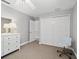 Bright bedroom with neutral walls, closet, and white dresser offers a calm and serene space at 208 Hideaway Ct, Minneola, FL 34715