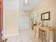 Bright foyer with neutral walls, white tile flooring, and a view of the living area at 208 Hideaway Ct, Minneola, FL 34715