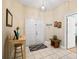 Bright foyer with neutral walls, white tile flooring, and decorative accents at 208 Hideaway Ct, Minneola, FL 34715