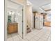 View of a hallway featuring a powder room and entryway to the kitchen at 208 Hideaway Ct, Minneola, FL 34715
