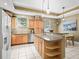 Bright kitchen with wood cabinets, granite countertops, stainless steel appliances, and a large island at 208 Hideaway Ct, Minneola, FL 34715