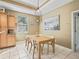 Kitchen featuring tile floors, wood cabinets, natural light, and a breakfast table at 208 Hideaway Ct, Minneola, FL 34715