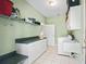 This laundry room has a washing machine, dryer, folding table, and cabinets for storage at 208 Hideaway Ct, Minneola, FL 34715