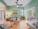 Living room showcasing hardwood floors, a ceiling fan, and sliding glass doors at 208 Hideaway Ct, Minneola, FL 34715
