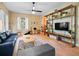 Bright living room with hardwood floors, ample natural light, and built-in shelving at 208 Hideaway Ct, Minneola, FL 34715