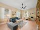 Bright living room with hardwood floors, ample natural light, and stylish furnishings at 208 Hideaway Ct, Minneola, FL 34715