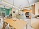 Open concept living area with view of the kitchen, tile floors, and hardwood floors at 208 Hideaway Ct, Minneola, FL 34715