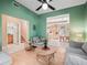 Living room showcasing hardwood floors, green walls, and views to kitchen and bathroom at 208 Hideaway Ct, Minneola, FL 34715