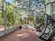 Relaxing screened-in patio featuring comfortable hanging chairs and a charming tiled floor at 208 Hideaway Ct, Minneola, FL 34715