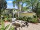 Exterior view of the home's back yard with a patio, fire pit, seating, and a screened in porch at 208 Hideaway Ct, Minneola, FL 34715
