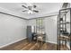 Bedroom featuring wood floors, ceiling fan, safe, desk and shelving unit at 2098 Hedgerow Cir, Ocoee, FL 34761