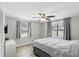 Light and airy bedroom with a ceiling fan, new windows, and neutral paint and flooring at 211 Agua Vista St, Debary, FL 32713