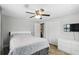 Bright bedroom with ceiling fan, closet, and en suite bathroom with modern vanity and large closet at 211 Agua Vista St, Debary, FL 32713