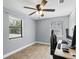 Bedroom with wood-look tile flooring, neutral colors, and lots of light from two windows at 211 Agua Vista St, Debary, FL 32713